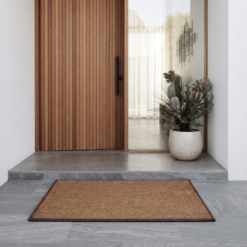 Coconut coir welcome mat at a front entrance
