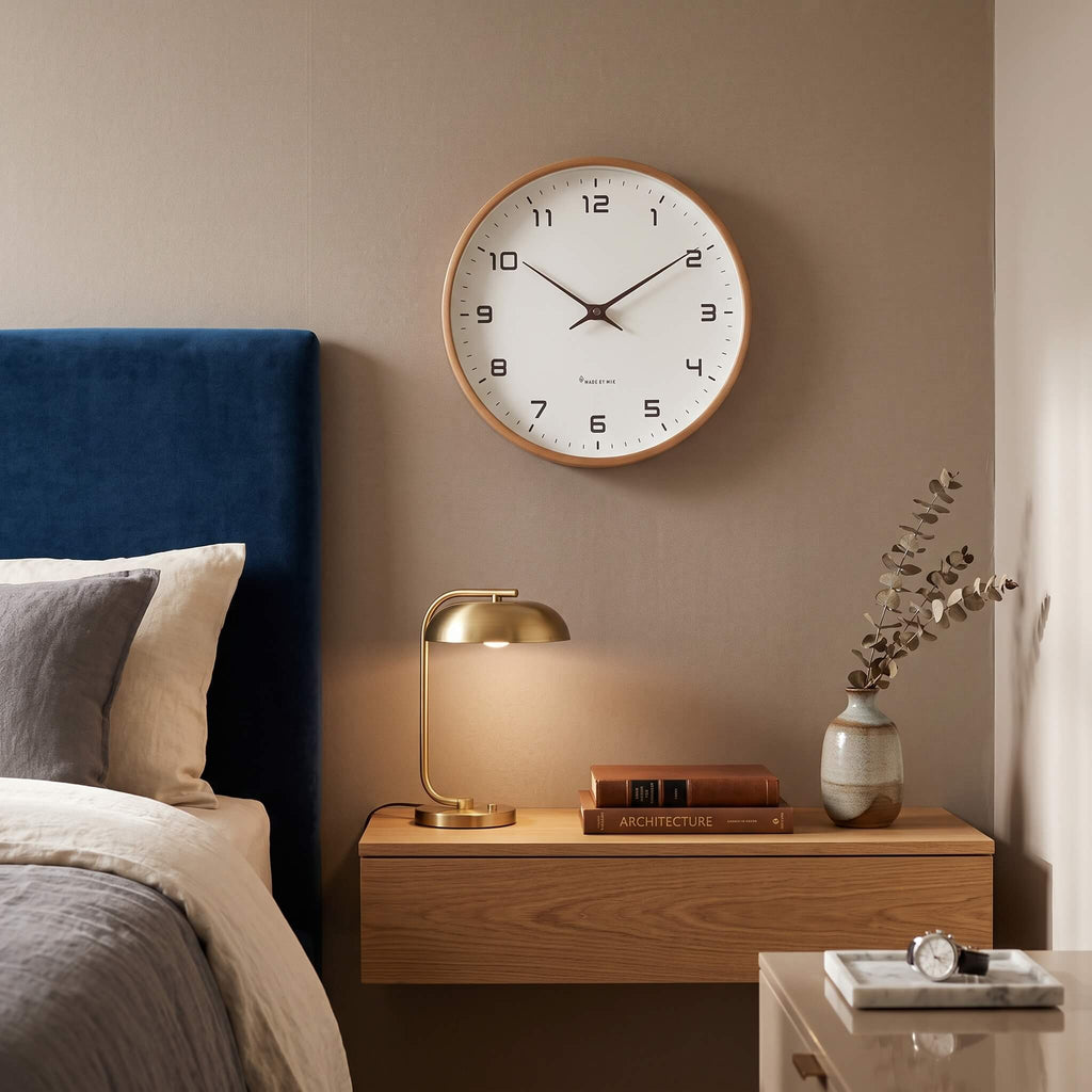 Natural timber frame and white face of the Nordic wall clock