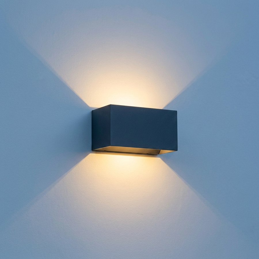 Aperture IP65 up down wall light mounted on a rendered exterior wall casting warm light above and below