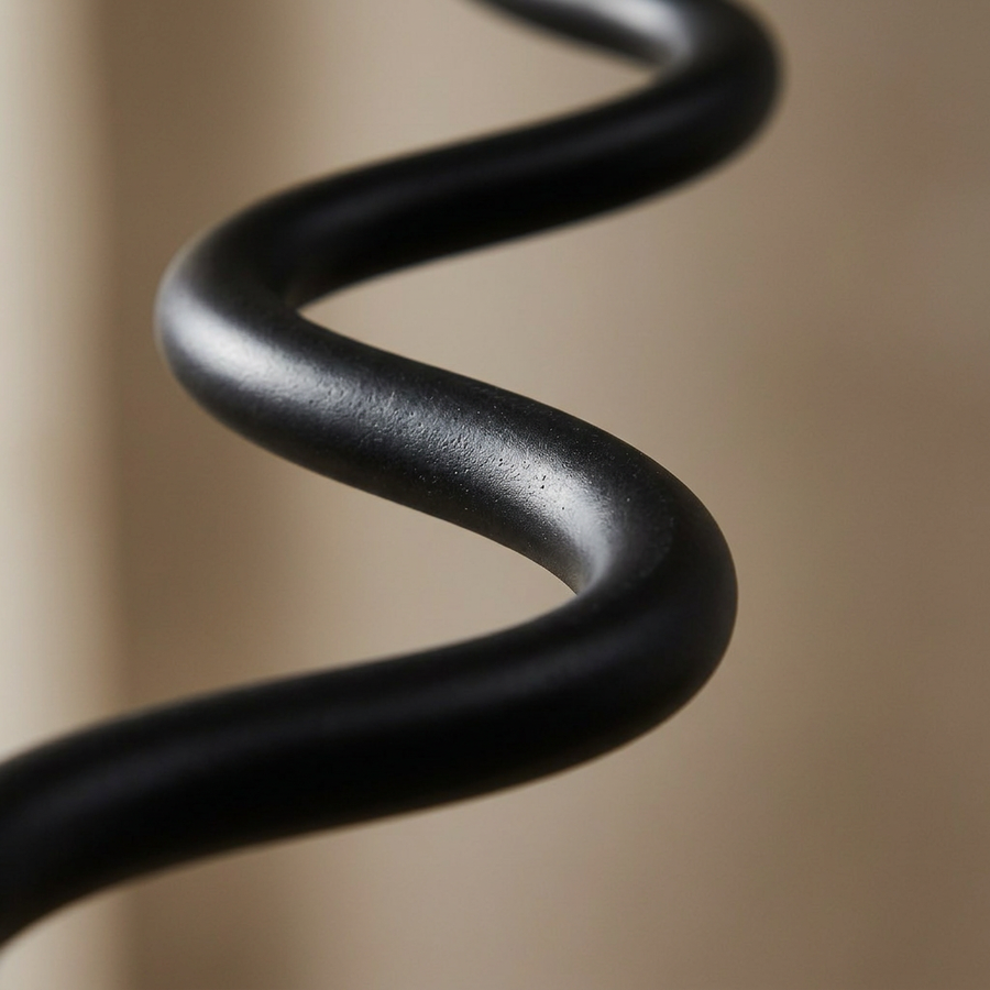 Close-up of the wavy black iron stem on the Meander Wavy Floor Lamp