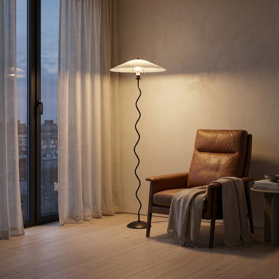 The Meander Wavy Floor Lamp beside a leather reading chair in a modern living room at dusk