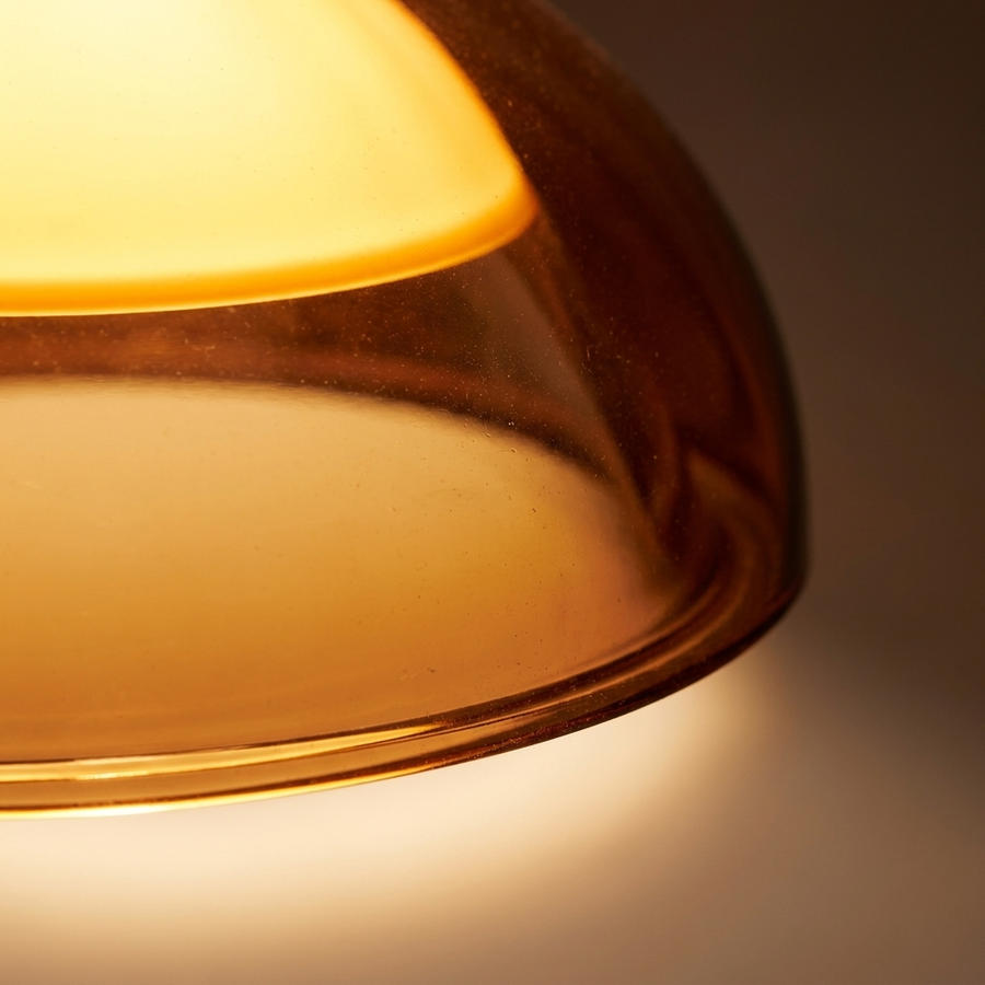 Close-up of the glowing amber mushroom dome shade on the Bauhaus Mushroom Floor Lamp