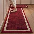Ruby Frame absorbent kitchen mat, deep red centre with a cream frame, on a timber floor