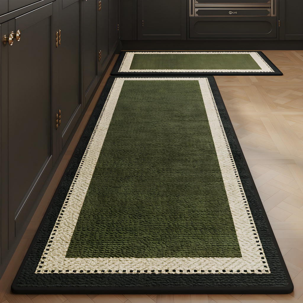 Forest Frame absorbent kitchen mat, forest green centre with a black frame, on a timber floor