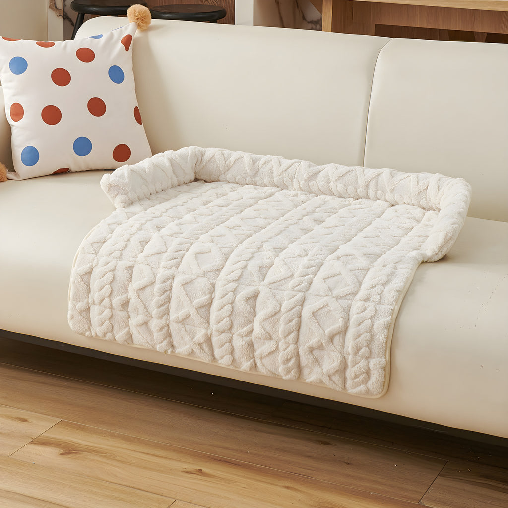 Ivory twist knit pet sofa mat on a cream sofa