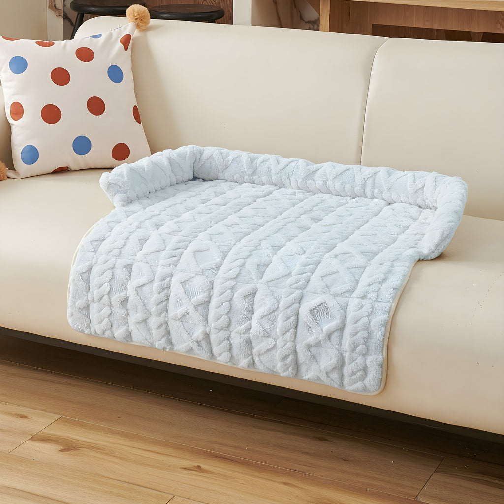 Ice blue twist knit pet sofa mat on a cream sofa