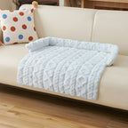 Ice blue twist knit pet sofa mat on a cream sofa