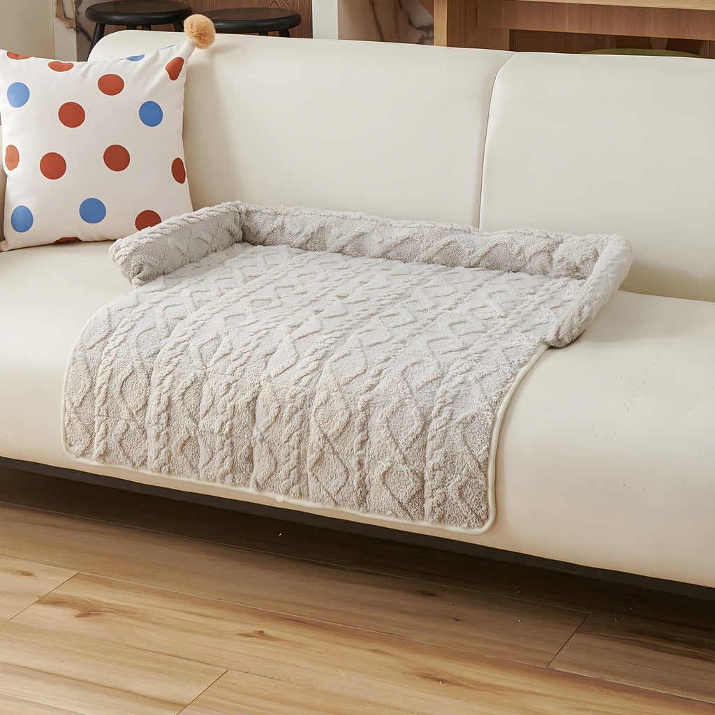 Light grey twist knit pet sofa mat on a cream sofa