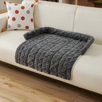 Charcoal twist knit pet sofa mat on a cream sofa