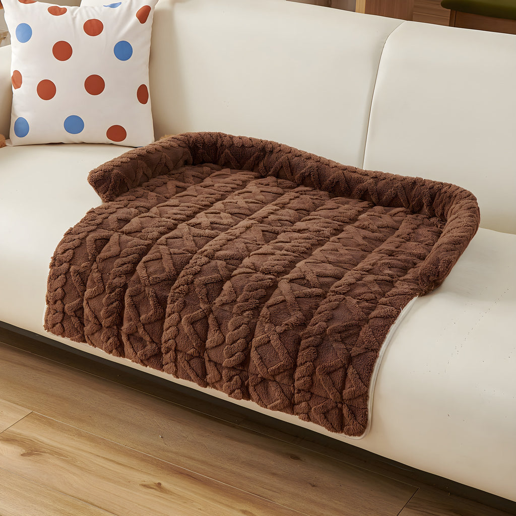 Mocha twist knit pet sofa mat on a cream sofa