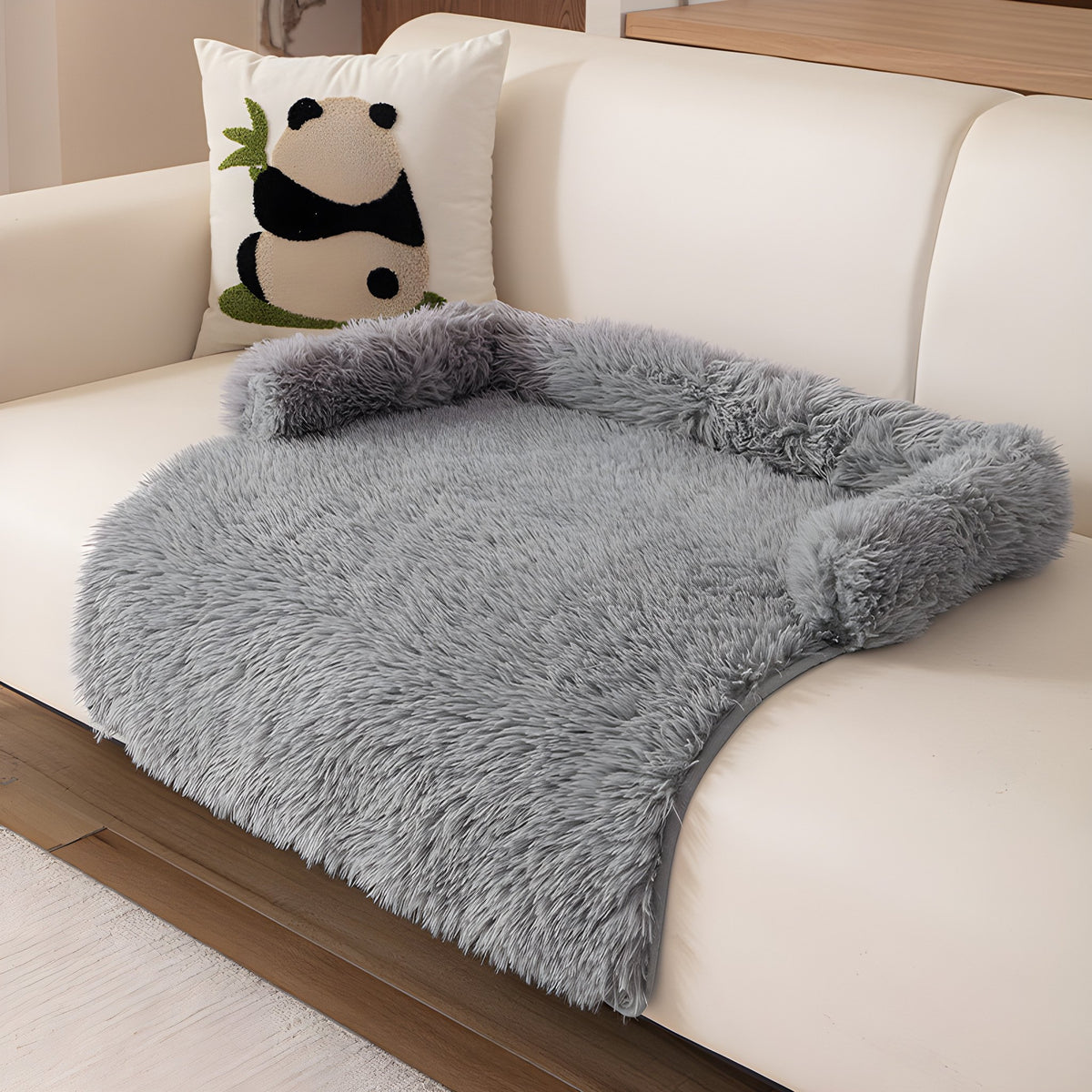 Grey fluffy nest pet sofa mat on a cream sofa