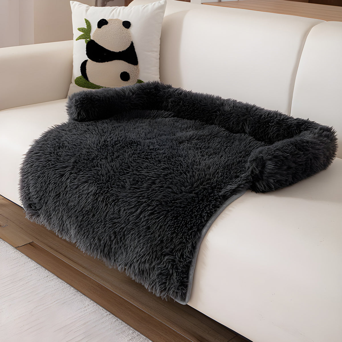 Charcoal fluffy nest pet sofa mat on a cream sofa