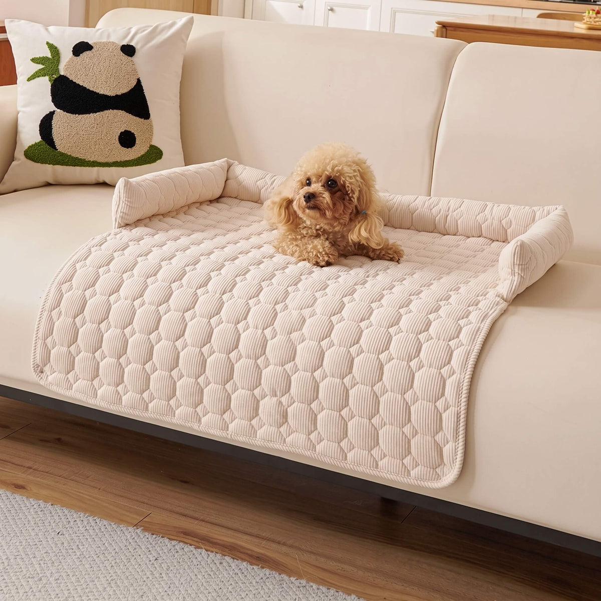 Cream quilted pet sofa mat on a cream sofa with a small dog