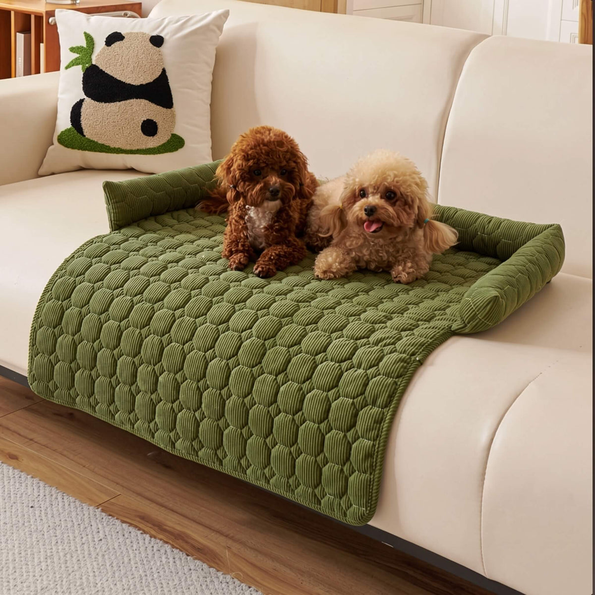 Olive green quilted pet sofa mat on a cream sofa with a small dog