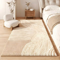 Dune faux cashmere bedroom rug, cream with soft sand-wave lines, beside a bed