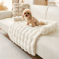 Ivory plush faux fur pet sofa mat on a cream sofa with a small dog sitting on it