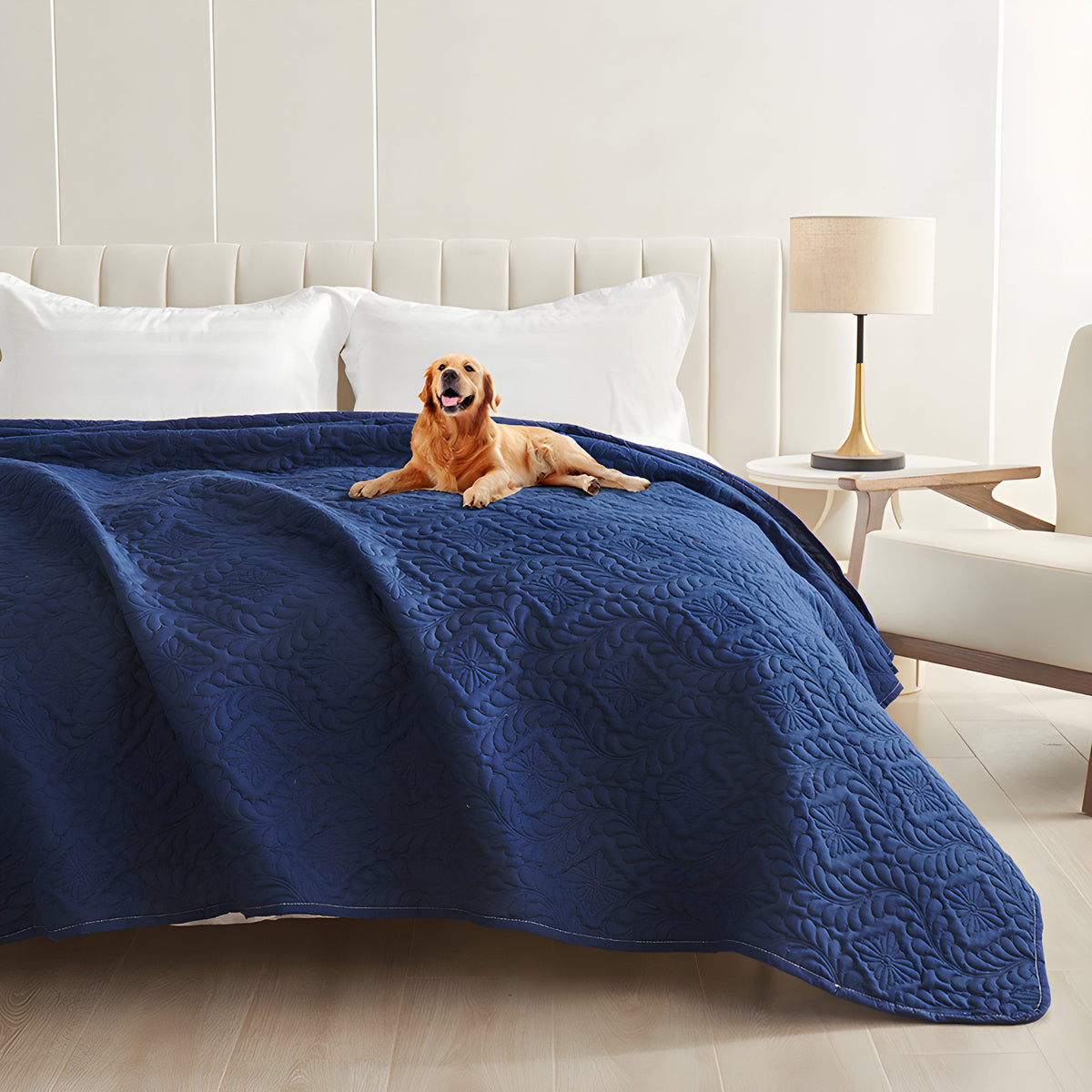 Dark blue quilted waterproof bed cover on a bed with a golden retriever lying on top