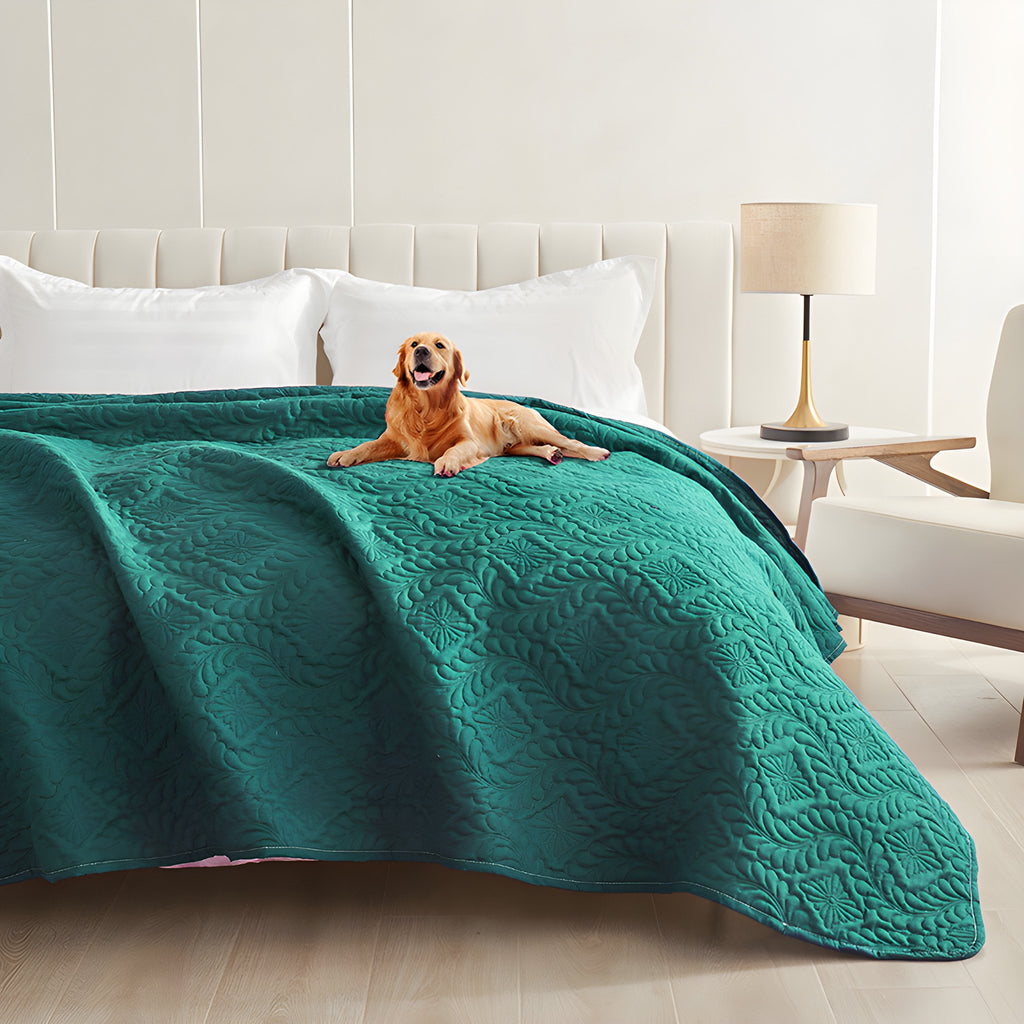 Emerald green quilted waterproof bed cover on a bed with a golden retriever lying on top