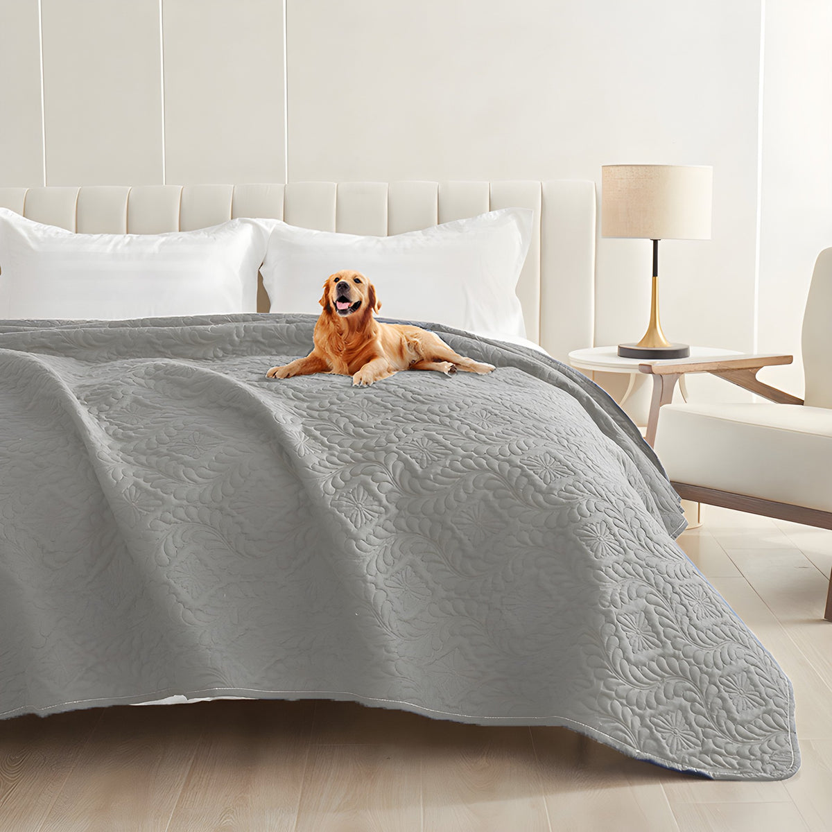 Grey quilted waterproof bed cover on a bed with a golden retriever lying on top