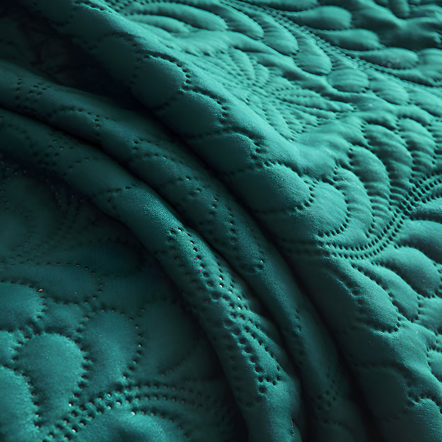 Close view of the emerald green quilted surface and its raised phoenix tail stitching